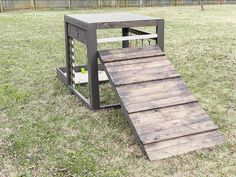 a wooden ramp made out of pallets in the grass