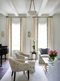 a living room filled with furniture and a piano