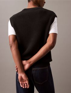 Crafted from soft compact cotton for refined comfort, this Calvin Klein vest is an ideal layering piece. Defined with a ribbed knit and cut in a relaxed fit. Styled with a V-neck for a classic silhouette.  Material: 100% Cotton.