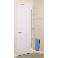 a white door and towel rack in a room