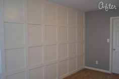 an empty room with white paneling on the wall and carpeted floor in front of it