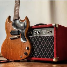 an electric guitar and amp sitting on a table