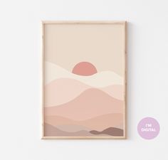 a pink and beige landscape with the sun setting in the distance, framed on a white wall