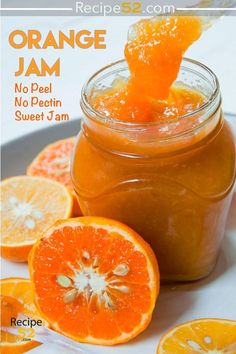 an orange jam in a glass jar on a plate with sliced oranges around it