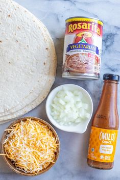 ingredients to make mexican chicken quesadilla laid out on a marble counter top