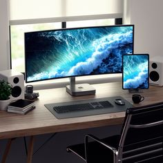 two computer monitors sitting on top of a wooden desk