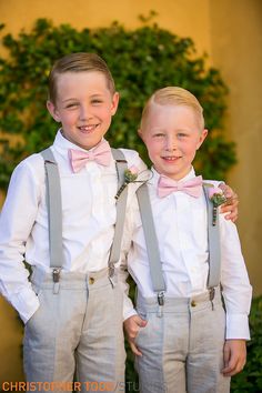 two young boys wearing bow ties and suspenders