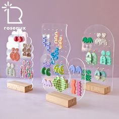 three clear acrylic displays with earrings on them