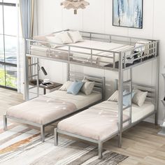 a bunk bed with two mattresses underneath it in a room next to a window