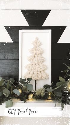 a white christmas tree sitting on top of a mantle