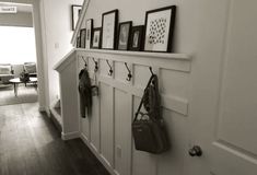 there is a coat rack on the wall with pictures and purses hanging from it