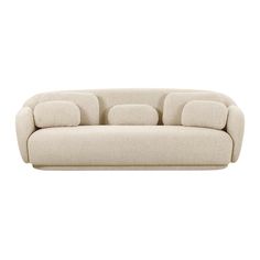 a white couch with three pillows on it