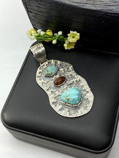 Artisan Turquoise and Mexican fire Opal pendant Hand-made Sterling Silver 925.  Stones used: Turquoise (Nevada), Mexican Fire Opal.  Height -3” (including bail), Width – 1 1/4”  Height – 75mm (including bail), Width – 35mmUnique Handcrafted One-of a-kind Design PendantEach Piece of Jewelry in my Collection is Absolutely One of a Kind!When you start wearing a piece of my jewelry you will fall in love with it more and more each day and feel that good Energy and Love that I pass into it while creat Southwestern Pendant Jewelry With Gemstones, Southwestern Style Gemstone Pendant Jewelry, Unique Untreated Turquoise Necklace Gift, Turquoise Pendant In Sterling Silver, Turquoise Sterling Silver Pendant Gemstone, Unique Untreated Turquoise Necklace As Gift, Turquoise Pendant Gemstone In Sterling Silver, Unique Untreated Turquoise Necklace For Gift, Southwestern Pendant Jewelry As Gift