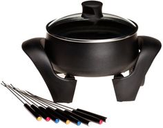 a black pot with a spoon on top of it