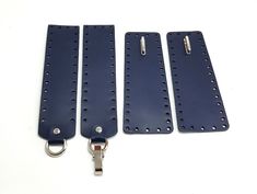 three pieces of blue leather with metal handles