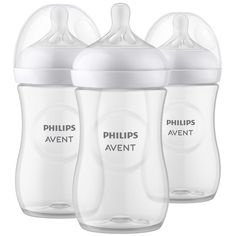 three philips avent bottles with the lids closed and one empty in white, on a white background