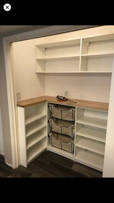 an empty room with shelves and bins in it