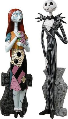 two figurines are standing next to each other