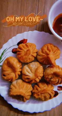 small dumplings on a plate with dipping sauce