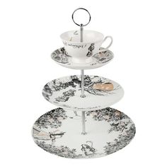 three tiered tray with two cups and saucers on it, one has an animal print