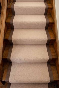 a carpeted stair case is shown with the bottom and bottom steps painted light brown