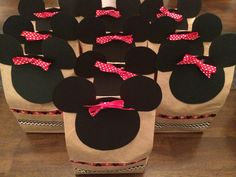 several mickey mouse ears with pink bows on them