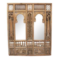 an ornate wooden cabinet with mirrors on it