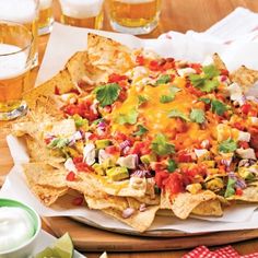 a platter with nachos and beer on the side