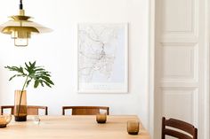 a dining room table with chairs and a plant