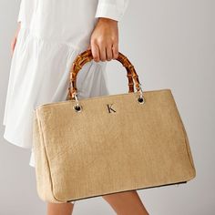 This stunning summer-inspired handbag is handcrafted from Italian raffia with polished bamboo handles. Thoughtfully constructed with an internal zippered section that divides the bag into three compartments, the classic silhouette is both simple and elegant, polished enough for formal occasions and relaxed enough for everyday use. Embroider a monogram to add a personal touch to this luxe gift for yourself or your favorite person.    15.25"w x 8"d x 10"h  Italian raffia with polished bamboo handl Navy Handbag, Italian Handbags, Wicker Bags, Suede Handbags, Straw Handbags, Mark And Graham, Embroidered Monogram, Red Handbag, Bamboo Handles