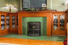 a living room with a fireplace and bookshelves