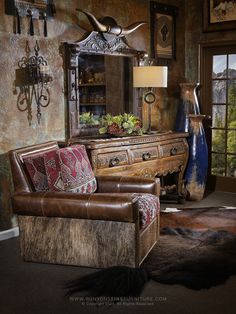 a living room filled with furniture and a large mirror over the top of a dresser