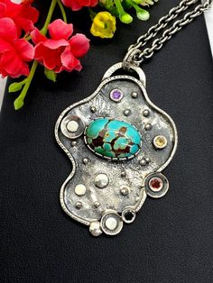 "ARTISAN ROYSTON TURQUOISE PENDANT comes with 20\" chain Hand-made Sterling Silver 925. Stones used: Royston Turquoise, Green Tourmaline, Sapphire, Amethyst. Height -2 1/2\" (with bail), Width - 1 3/4\" Height - 62mm, width-45mm. Unique Handcrafted One-of a-kind Design Pendant. Each Piece of Jewelry in my Collection is Absolutely One of a Kind! When you start wearing a piece of my jewelry you will fall in love with it more and more each day and feel that good Energy and Love that I pass into it Artistic Oval Sterling Silver Necklaces, Artistic Oval Sterling Silver Necklace, Artistic Oval Silver Necklace, Unique Sterling Silver Cabochon Turquoise Necklace, Elegant Handmade Turquoise Chrysocolla Necklace, Spiritual Turquoise Necklace Collectible, Artisan Turquoise Necklace With Oxidized Finish, Collectible Turquoise Necklaces With Natural Stones, Unique Turquoise Oval Pendant Jewelry