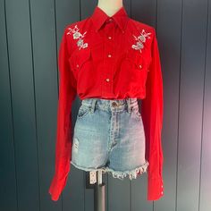 "^ Red Western Pearl Snap Shirt with Sawtooth Chest Pockets and Floral Embroidery on Yoke. Size M/L (see measurements) Size Label Vintage: can't read Content: 100% Cotton Label: Cowhand ^ Please note specific garment measurements below: Bust: 22\" (44\" Doubled) armpit to armpit when closed Length: 29\" Sleeve: 27\" * condition * Good: seams loose and collar tips showing white Follow us on IG @bbwestvintage https://www.instagram.com/bbwestvintage/ I do not accept returns currently. Please read the description and measurements in detail. Ask away any and all questions before you purchase. However, if you do have a problem with your purchase, please message me as I am flexible on a case by case basis." Red Embroidered Long Sleeve Shirt, Fitted Embroidered Red Shirt, Fitted Red Embroidered Shirt, Red Cotton Shirt With Floral Embroidery, Vintage Red Tops With Floral Embroidery, Red Vintage Tops With Floral Embroidery, Western Pearl Snap, Collar Tips, Pearl Snap Shirt