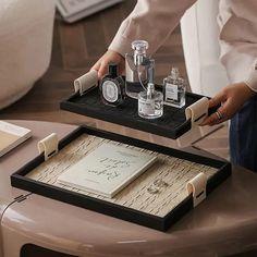 two trays that have bottles on top of each other with writing and ink in them