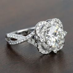 a diamond ring on a wooden table with diamonds in the center and around it's shants