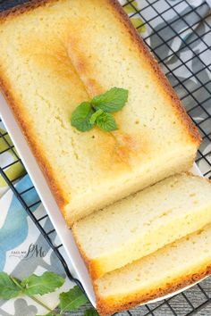 two slices of lemon pound cake on a cooling rack with fresh mint sprig