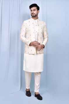 Cream jacket with thread embroidered floral butta. Paired with matching kurta and pant. - Aza Fashions Eid Nehru Jacket With Cutdana On Raw Silk, Bollywood Style Naqshi Bandhgala For Festive Occasions, Fitted Kurta With Chikankari Embroidery And Stand Collar, Traditional Suits With Chikankari Embroidery For Festive, Ceremonial Nehru Jacket With Zari Work In Raw Silk, Raw Silk Nehru Jacket With Resham Embroidery, Festive Suits With Chikankari Embroidery, Festive Bandhgala With Chikankari Embroidery And Stand Collar, Festive Front Open Sets With Chikankari Embroidery