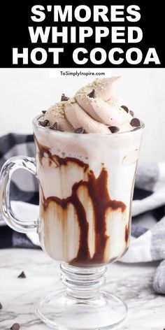 a glass cup filled with hot chocolate and whipped cream