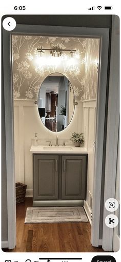 an image of a bathroom with a mirror on the wall and lights in the doorway