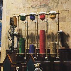 several different colored candles are lined up on the wall