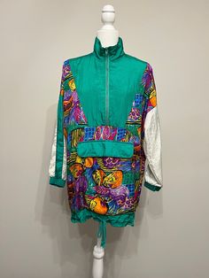 "Oh wow This jacket is 80s fabulous!  It is by Avait Sport, sometime mid 80s to early 90s.  It has a bold kelly green as its predominant color and a rainbow of other bright colors in a fruit pattern.  This jacket definitely makes a statement!  It's baggy and oversized in a size Small.  Please see measurements below.  You may want to size down depending upon how you want it to fit.  It has a drawstring bottom and hangs longer than some of the other track jackets from this era that have banded bottoms.  I just love this jacket I love when an item represents its era so well.  The jacket is in excellent condition!  It's 100% nylon fabric.  It's vintage fabulous!  Thanks for looking! Measurements taken laying flat: please double for chest & waist Armpit to armpit 24\" Waist/middle 23\" Sleeves Green Long Sleeve Patchwork Windbreaker, Green Patchwork Long Sleeve Track Jacket, Green Long Sleeve Patchwork Track Jacket, Oversized Green Windbreaker For Spring, Green Oversized Windbreaker For Spring, Spring Outdoor Patchwork Windbreaker, Patchwork Nylon Windbreaker For Spring, Retro Long Sleeve Windbreaker For Spring, Retro Long Sleeve Spring Windbreaker