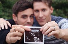 two men are holding up an x - ray image