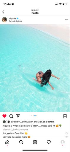 a woman is floating in the water on her surfboard