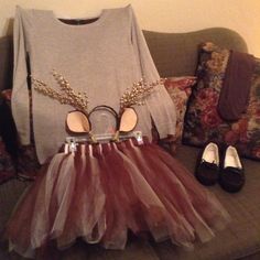 a dress and shoes are sitting on a couch next to a t - shirt with ears