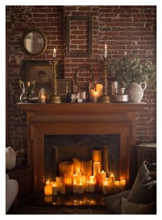 a fire place with many lit candles in it