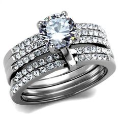 a diamond ring and wedding band set on top of each other