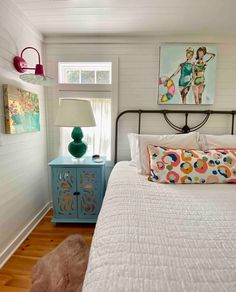 a bedroom with white walls and wood floors