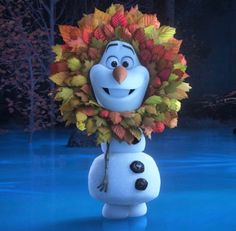 the snowman is dressed as a leaf wreath