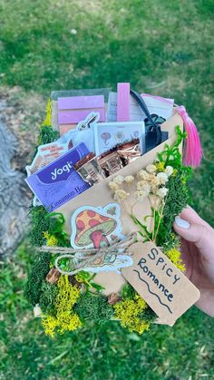 a person holding a bag filled with lots of stuff in it's hands and some stickers on the back